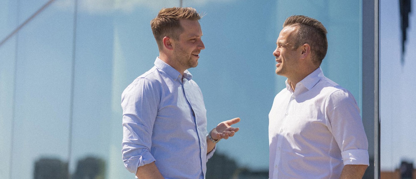 Two colleagues engaging in conversation outside in Copenhagen